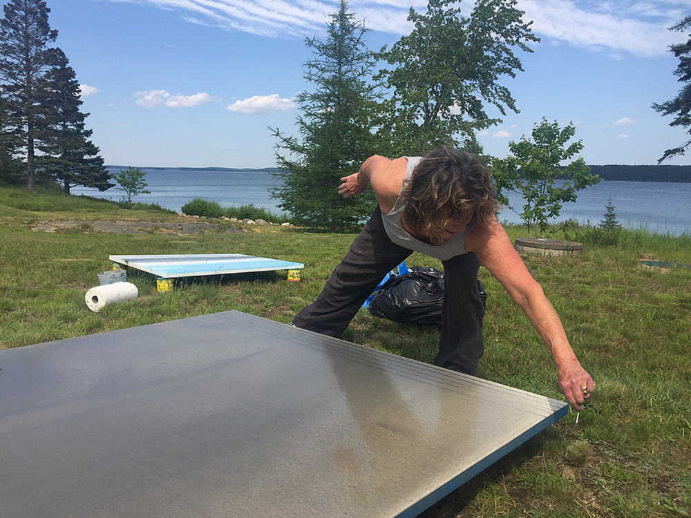 Anne Neely painting outside her studio in Jonesport, ME